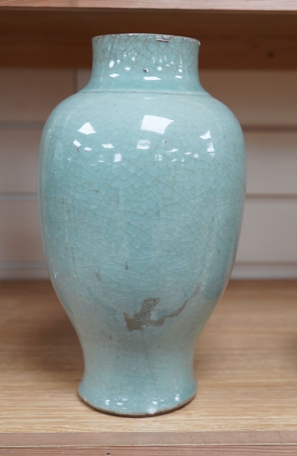 A 17th century Chinese celadon crackle glazed vase, 29cm. Condition - ground down
